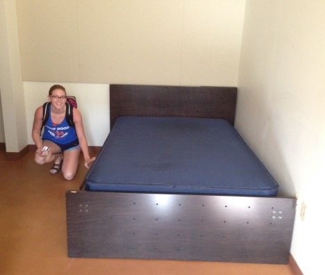 Claire checks out her new bed in her dorm room